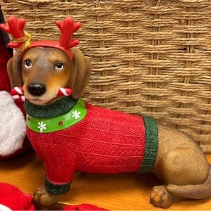Festive dachshund in red Sweater with Antlers and candy cane in mouth